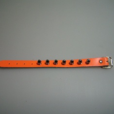 armband leer oranje 1 rij spikes 